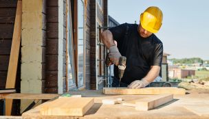 Man in Black Shirt Holding Black Power Tool